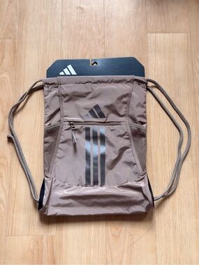 NWT Adidas taupe drawstring bag, multiple pockets, ~13x18”